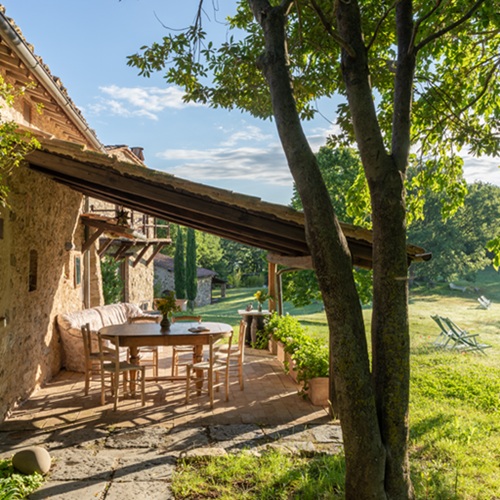 Outdoor patio and table with sunlight at Tuscany retreat